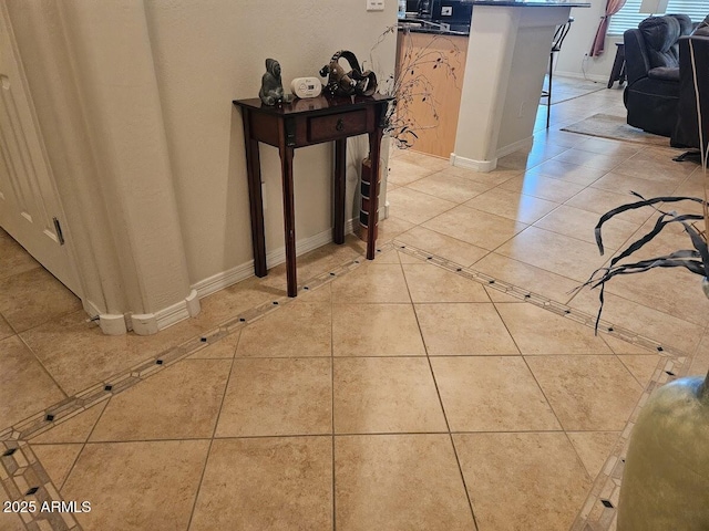 hall with light tile patterned floors and baseboards