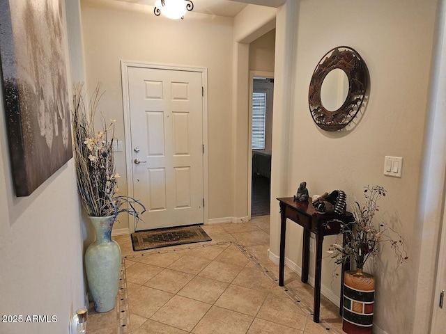 entrance foyer featuring baseboards and light tile patterned flooring