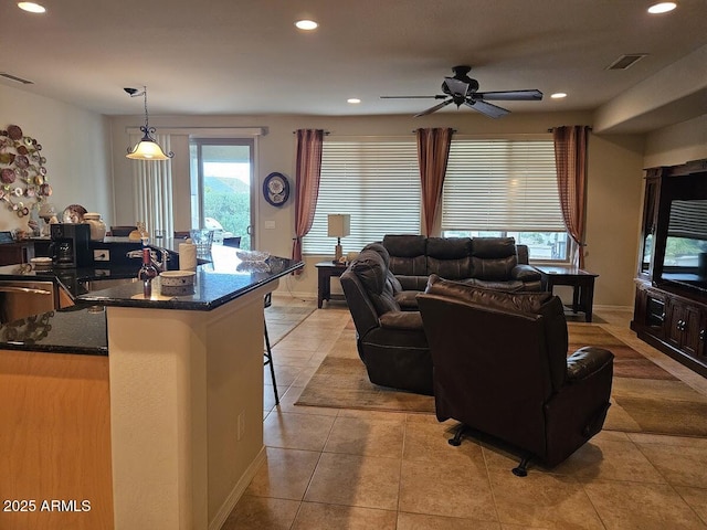 living area with visible vents, recessed lighting, ceiling fan, and light tile patterned floors
