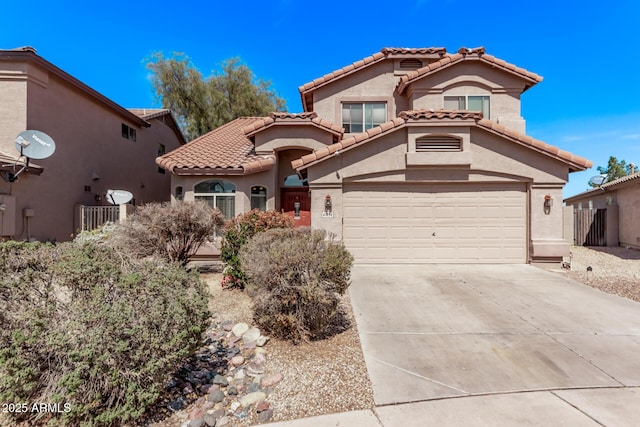 mediterranean / spanish-style home featuring a garage, driveway, stucco siding, and a tiled roof