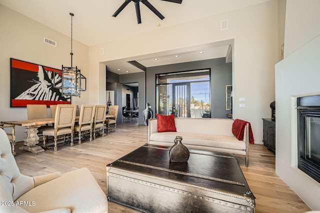 living room with hardwood / wood-style floors and ceiling fan