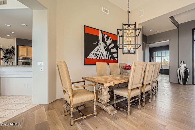 dining room featuring light hardwood / wood-style floors and an inviting chandelier