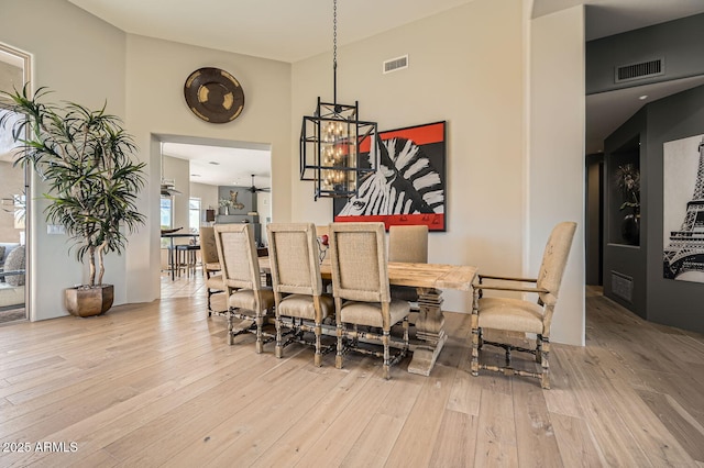 dining space featuring a chandelier and light wood-type flooring