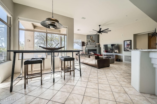 tiled dining area with ceiling fan