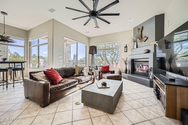 living room featuring ceiling fan, a healthy amount of sunlight, and light tile patterned floors