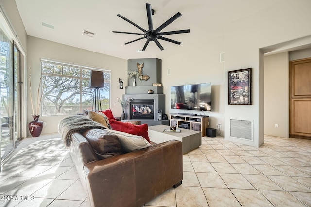 tiled living room featuring ceiling fan and plenty of natural light