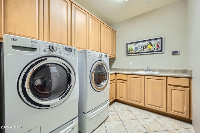 washroom with light tile patterned flooring, cabinets, separate washer and dryer, and sink