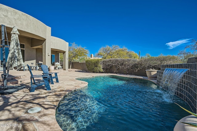 view of pool with pool water feature and a patio area