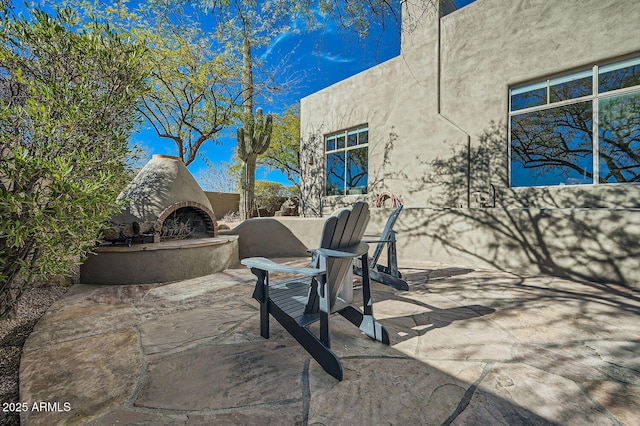 view of patio featuring an outdoor fireplace