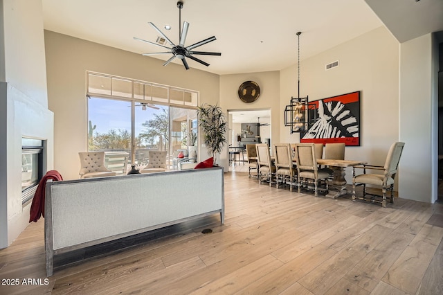 living room with ceiling fan and light wood-type flooring