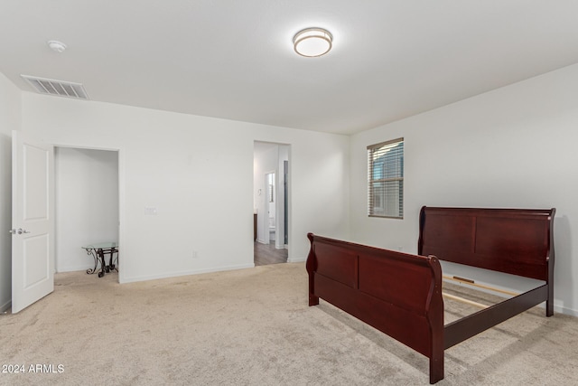 bedroom featuring light colored carpet