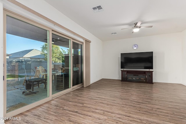 unfurnished living room with ceiling fan and wood-type flooring