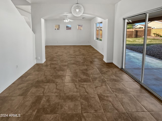 tiled empty room with ceiling fan