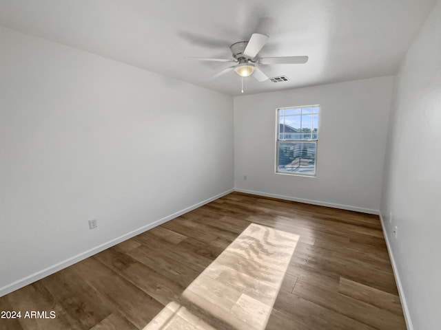 spare room featuring ceiling fan and dark hardwood / wood-style floors