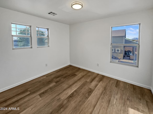 unfurnished room featuring dark hardwood / wood-style floors