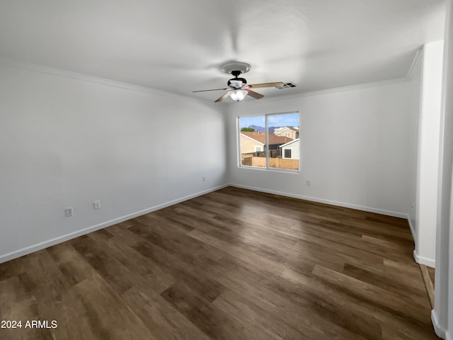 spare room featuring ornamental molding, ceiling fan, and dark hardwood / wood-style floors