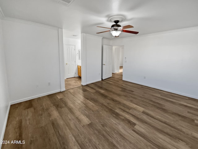 unfurnished bedroom featuring crown molding, dark wood-type flooring, connected bathroom, and ceiling fan