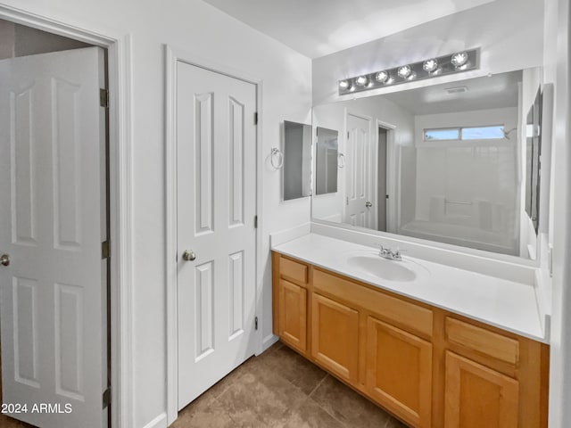 bathroom featuring tile floors and vanity