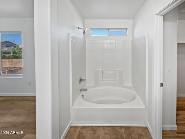 bathroom with plenty of natural light,  shower combination, and hardwood / wood-style floors