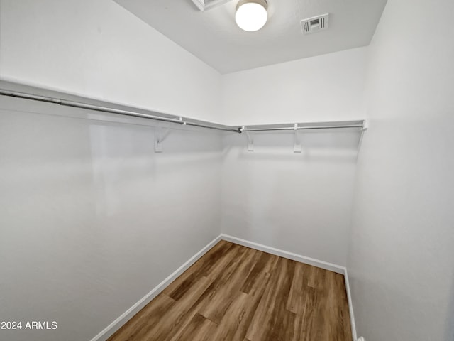 spacious closet with hardwood / wood-style floors