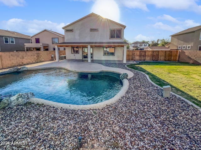 view of swimming pool with a lawn and a patio