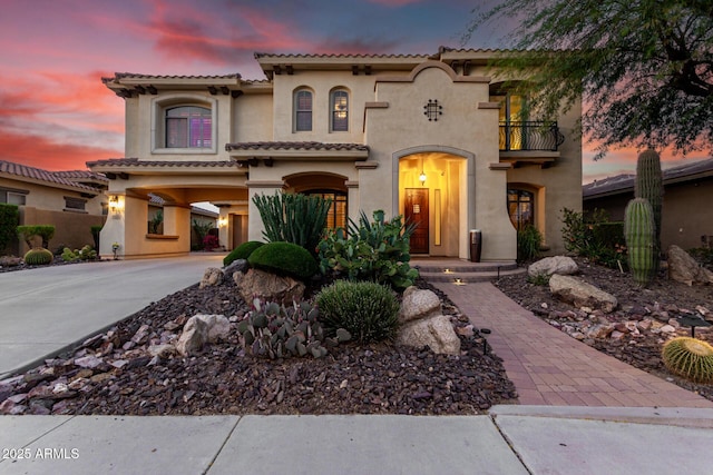 13336 W Via Caballo Blanco, Peoria, AZ 85383 - mediterranean / spanish house with a balcony, driveway, a carport, a tiled roof, and stucco siding