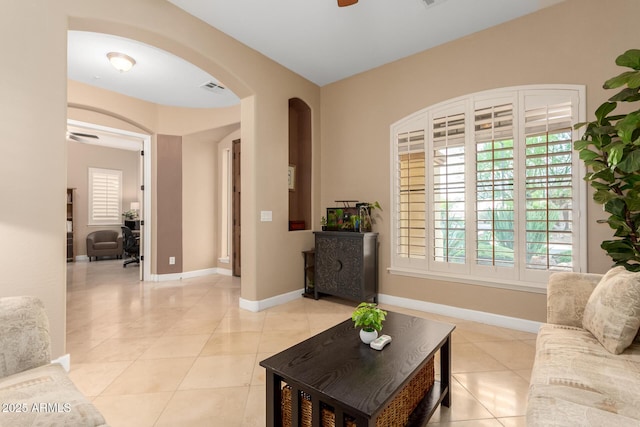 13336 W Via Caballo Blanco, Peoria, AZ 85383 - living room with baseboards, arched walkways, visible vents, and light tile patterned floors