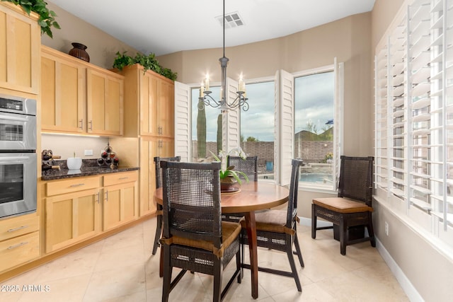 13336 W Via Caballo Blanco, Peoria, AZ 85383 - dining area with baseboards, light tile patterned flooring, a chandelier, and visible vents