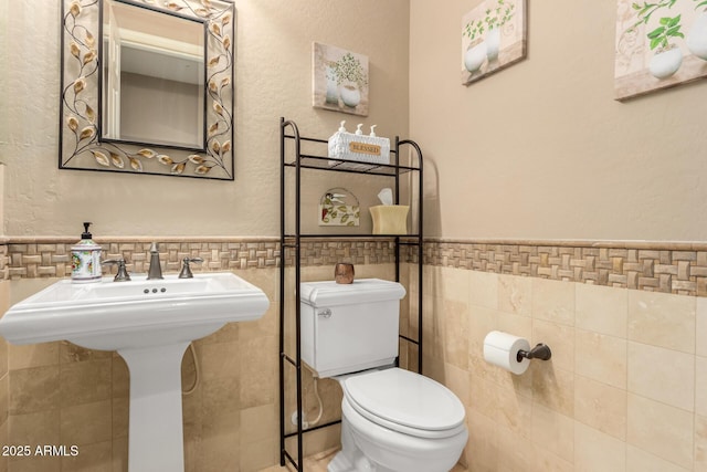 13336 W Via Caballo Blanco, Peoria, AZ 85383 - bathroom featuring tile walls, wainscoting, and toilet