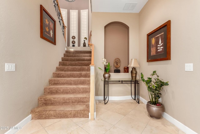 13336 W Via Caballo Blanco, Peoria, AZ 85383 - stairway featuring arched walkways, tile patterned floors, visible vents, and baseboards