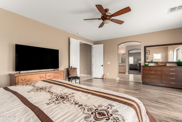 13336 W Via Caballo Blanco, Peoria, AZ 85383 - bedroom featuring arched walkways, light wood-style floors, visible vents, and ceiling fan