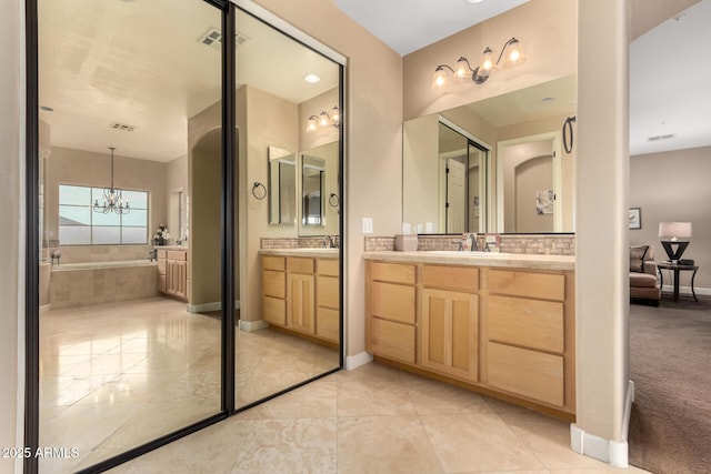 13336 W Via Caballo Blanco, Peoria, AZ 85383 - full bath with a garden tub, a notable chandelier, two vanities, and visible vents