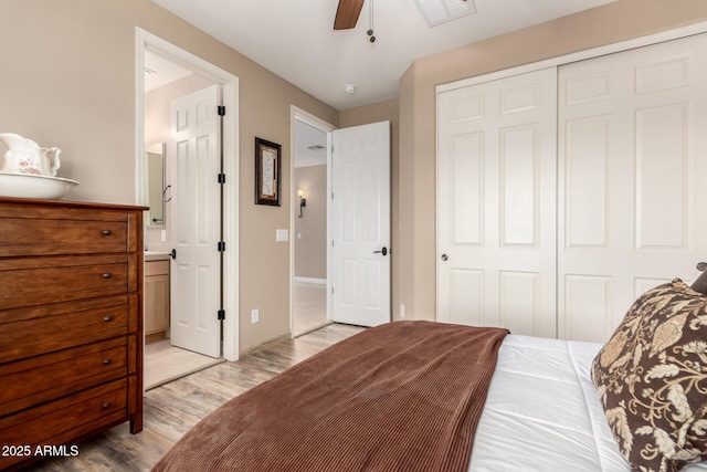 13336 W Via Caballo Blanco, Peoria, AZ 85383 - bedroom featuring a ceiling fan, a closet, connected bathroom, light wood-type flooring, and visible vents