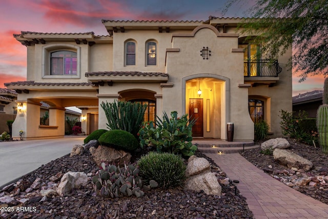 13336 W Via Caballo Blanco, Peoria, AZ 85383 - mediterranean / spanish house with concrete driveway, a tiled roof, a balcony, and stucco siding