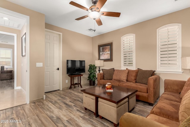 13336 W Via Caballo Blanco, Peoria, AZ 85383 - living room with visible vents, baseboards, a ceiling fan, and wood finished floors