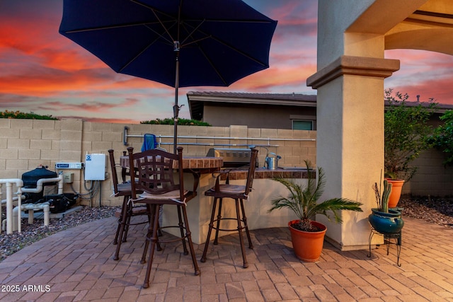 13336 W Via Caballo Blanco, Peoria, AZ 85383 - patio terrace at dusk featuring outdoor dry bar and fence