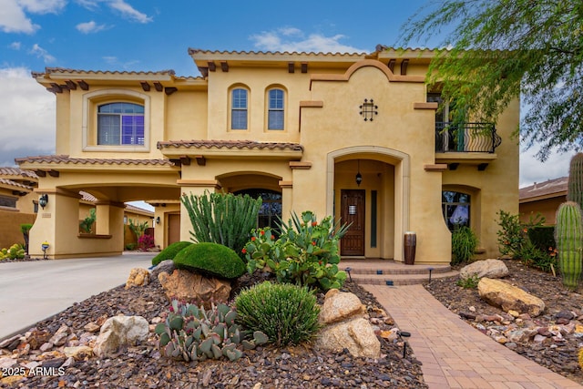 13336 W Via Caballo Blanco, Peoria, AZ 85383 - mediterranean / spanish-style house with a balcony, driveway, a tiled roof, a garage, and stucco siding