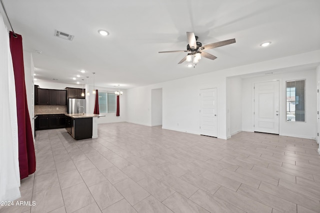 unfurnished living room with ceiling fan and sink