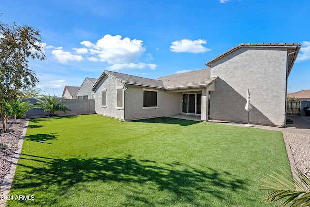 rear view of house with a yard