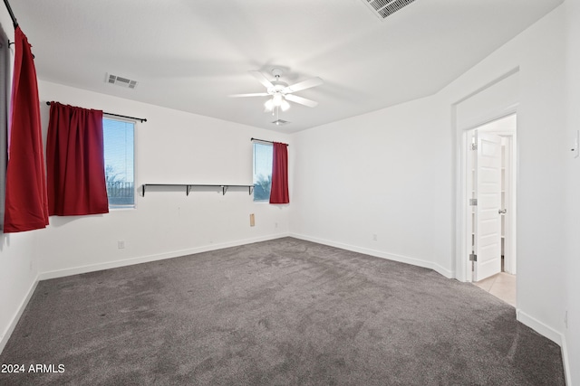 carpeted empty room featuring ceiling fan