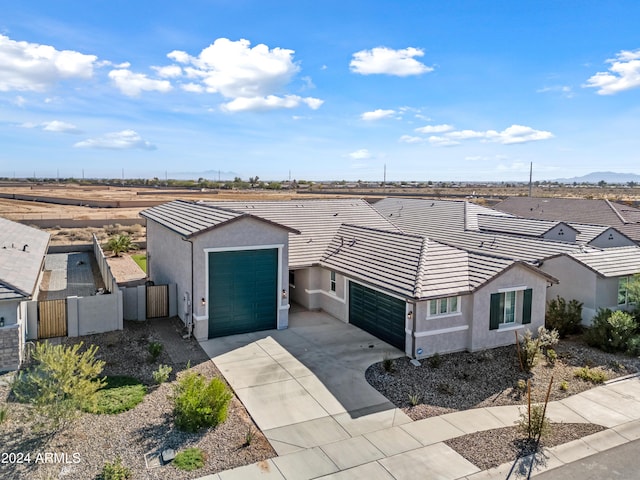 view of front of property with a gate, fence, a tiled roof, and stucco siding