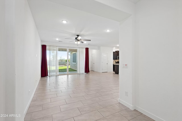 empty room featuring ceiling fan and light tile patterned floors