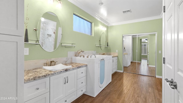 bathroom with wood-type flooring, vanity, and crown molding