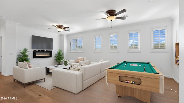 recreation room with light hardwood / wood-style floors, ceiling fan, and crown molding