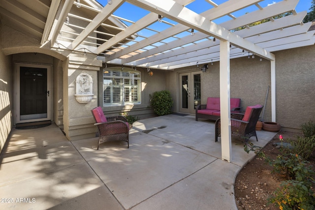 view of patio / terrace featuring french doors and a pergola