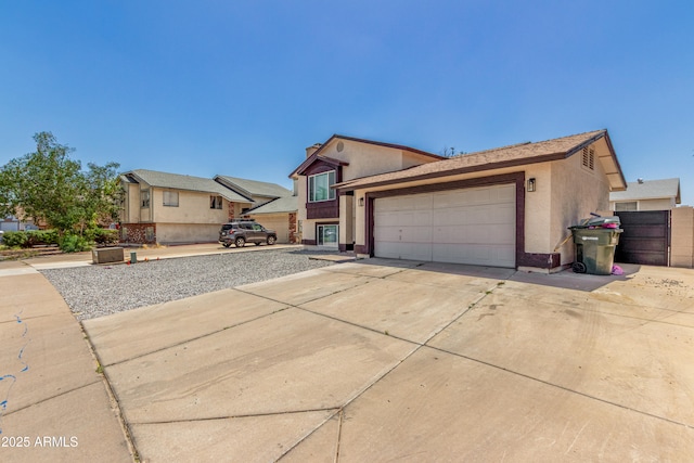view of front of home featuring concrete driveway, a garage, and stucco siding