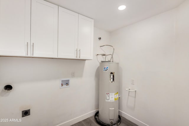 laundry area with cabinet space, electric water heater, baseboards, hookup for an electric dryer, and wood finished floors