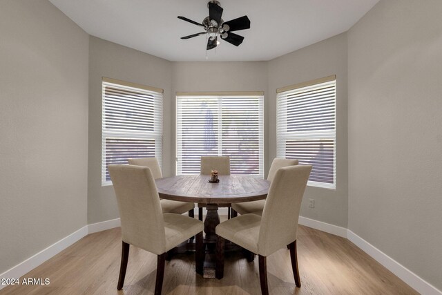 dining room featuring ceiling fan, light wood-type flooring, and a wealth of natural light