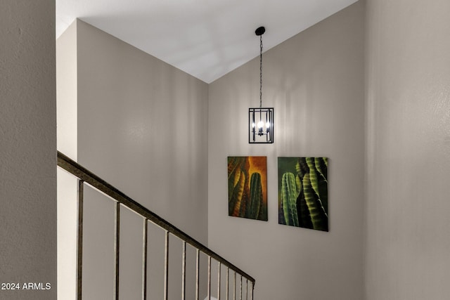 staircase with vaulted ceiling and a chandelier