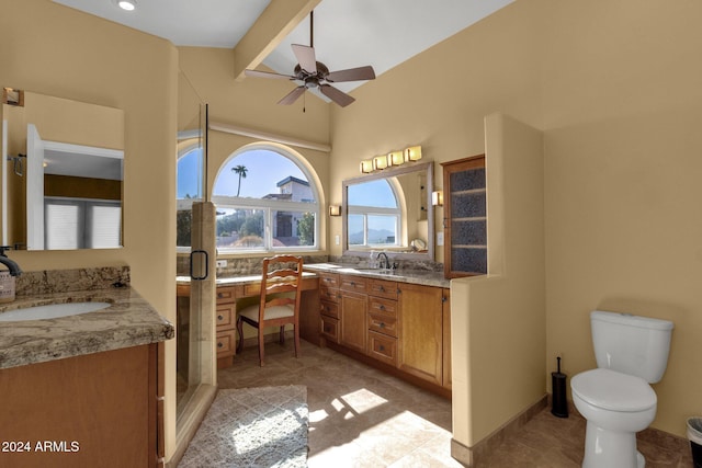 bathroom with vanity, toilet, walk in shower, and ceiling fan